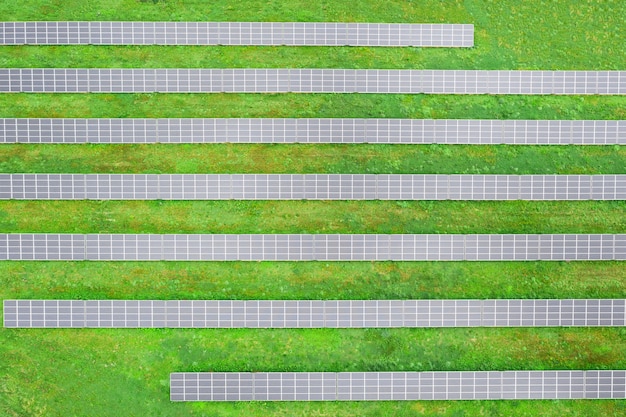 Solar farm on the field, many solar panels in a row. Alternative power source