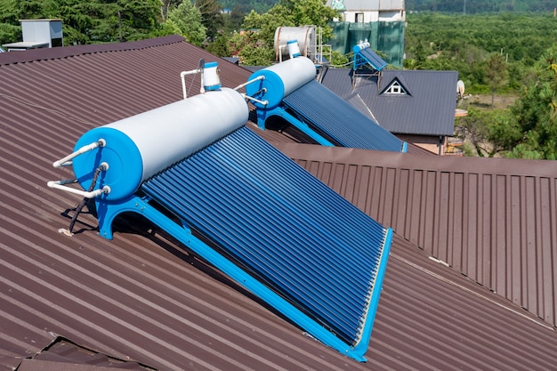 Photo solar glass tube hot water panel array mounted on a roof, technology.