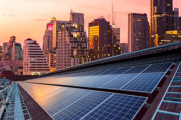 Solar Panel Photovoltaic installation on a Roof of factory, sunny blue sky background, alternative electricity source - Sustainable Resources Concept.