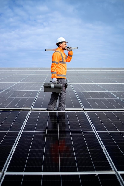 Solar panel serviceman walking on the roof