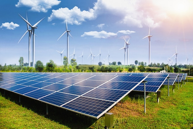 Photo solar panel with wind turbines against mountains and sky