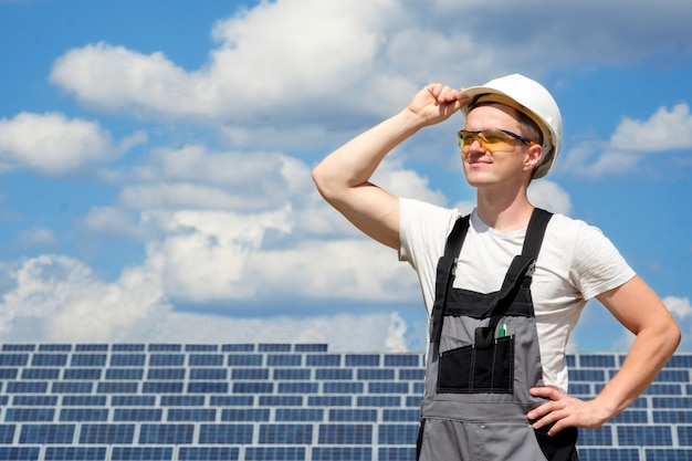 Solar panels engineer in white helmet