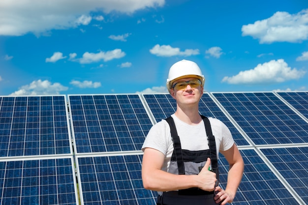 Solar panels engineer in white helmet