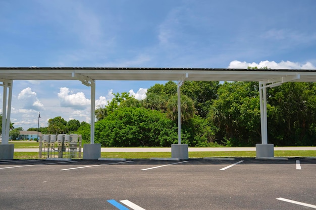 Solar panels installed as shade roof over parking lot for parked electric cars for effective generation of clean electricity Photovoltaic technology integrated in urban infrastructure