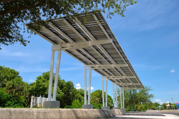 Solar panels installed as shade roof over parking lot for parked electric cars for effective generation of clean electricity Photovoltaic technology integrated in urban infrastructure