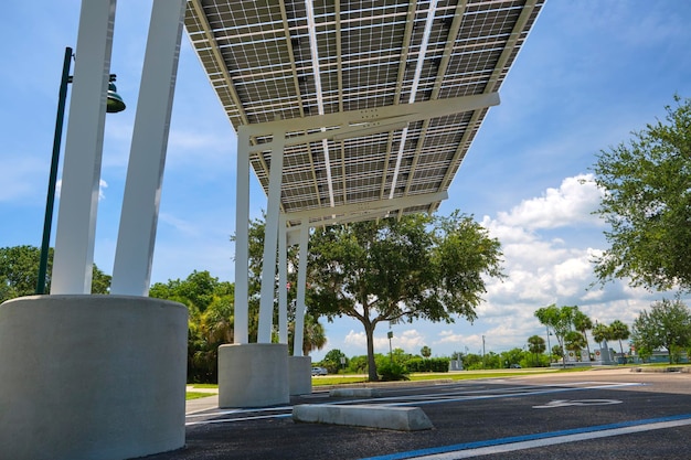 Solar panels installed over parking lot canopy shade for parked cars for effective generation of clean energy