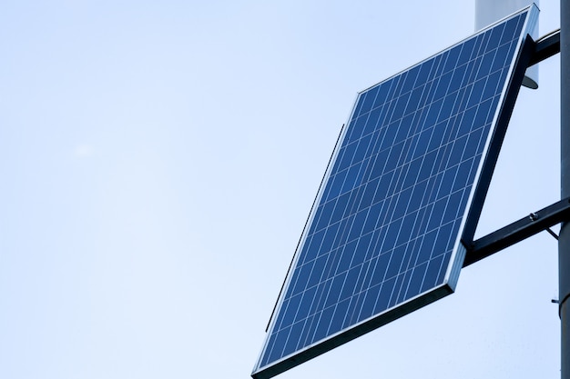  solar panels on pillar against sky background. Public city light with solar panel powered on blue sky with clouds