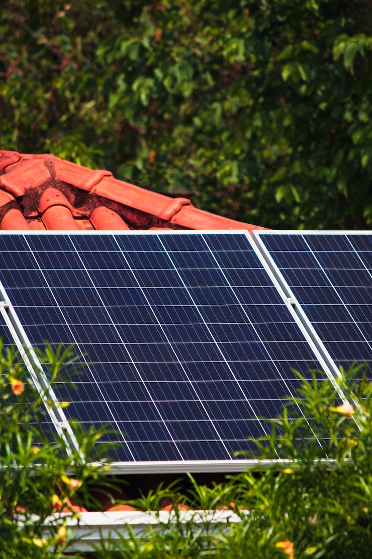 Photo solar panels on the red roof house in a sunny and cloudy day. photovoltaic solar energy instalation concept image.