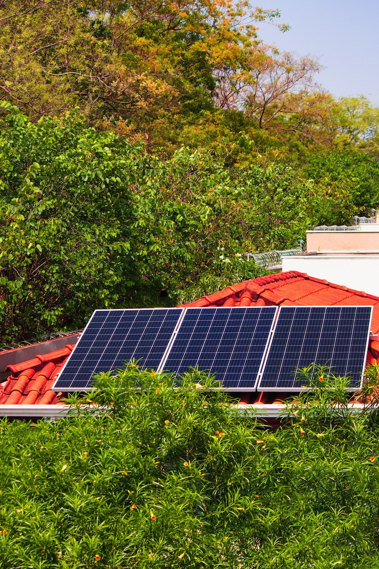 Photo solar panels on the red roof house in a sunny and cloudy day. photovoltaic solar energy instalation concept image.