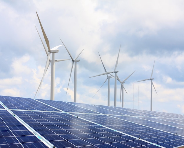 Photo solar panels and wind turbines with the clouds and sky, renewable energy