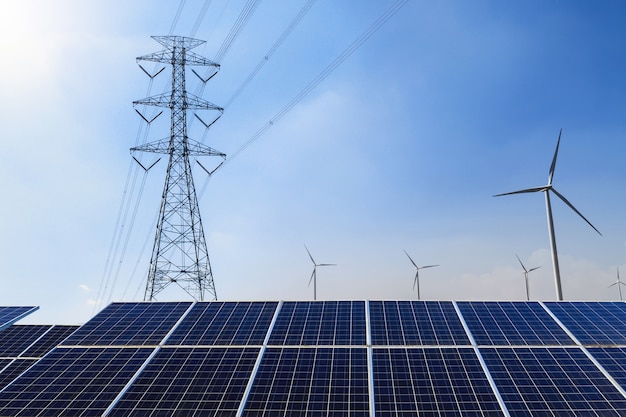 solar panels with electricity pylon and wind turbine clean power energy concept