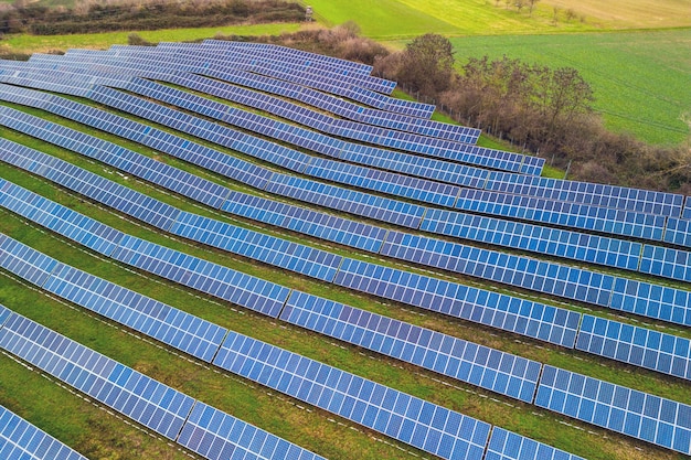 An solar park system between fields and meadows in germany from a drone perspective