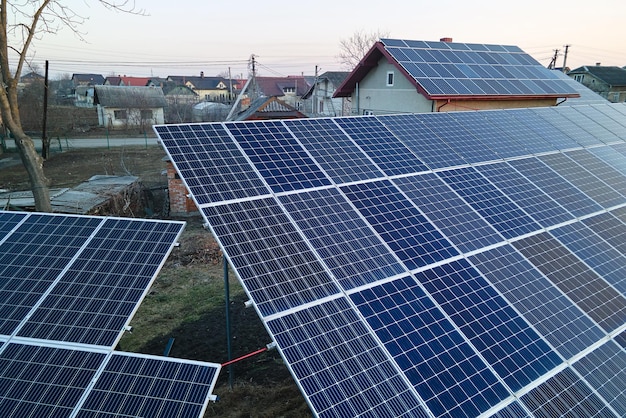 Solar photovoltaic panels for producing of clean ecological electrical energy mounted on backyard ground in suburban rural area Concept of autonomous home