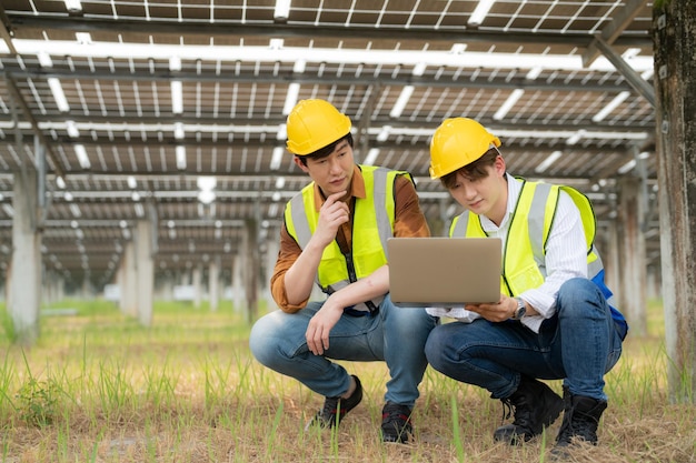 Solar power plant engineer examining photovoltaic panels technician maintenance electric solution