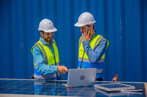 Solar power plant engineers meeting and examining photovoltaic\
panels concept of alternative energy and its service engineer\
energy power man worker at site