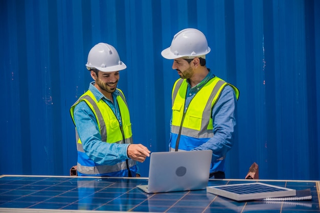 Solar power plant engineers meeting and examining photovoltaic
panels concept of alternative energy and its service engineer
energy power man worker at site