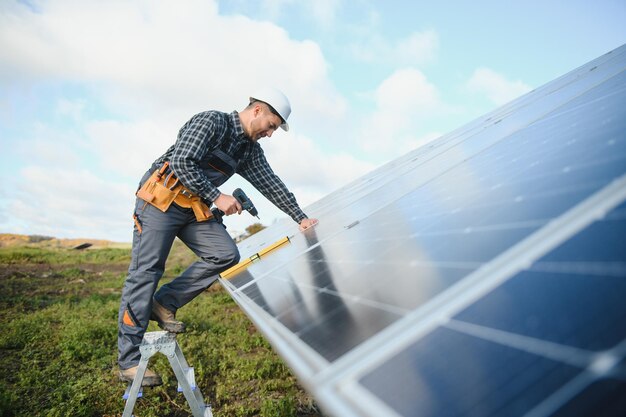 Solar power plant worker checks the condition of the panels