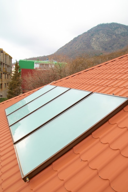 Solar water heating system geliosystem on the red house roof.