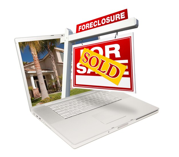 Photo sold foreclosure home for sale real estate sign laptop