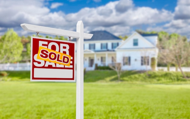 Photo sold home for sale sign in front of new house