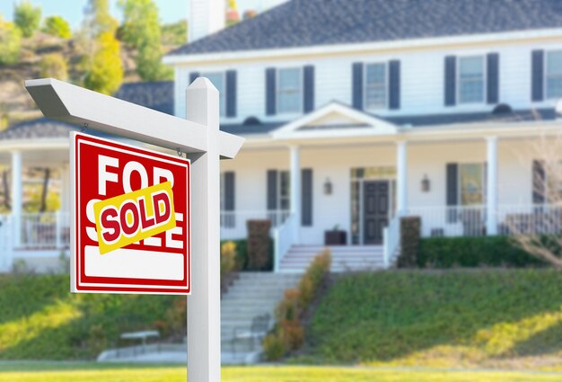 Sold For Sale Real Estate Sign in Front of New House