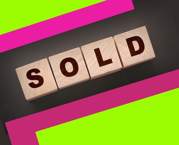 Sold Word Written In Wooden Cubes Real estate business concept