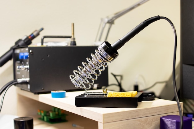 Soldering iron in a metal stand closeup