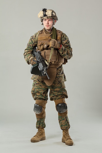 Soldier in camouflage holding rifle