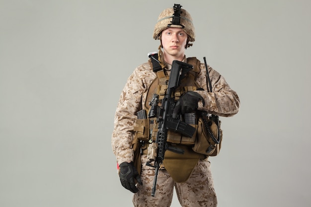 Soldier in camouflage holding rifle