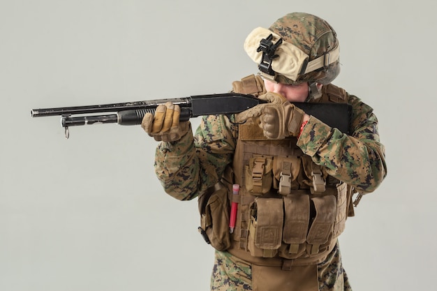 Soldier in camouflage holding rifle