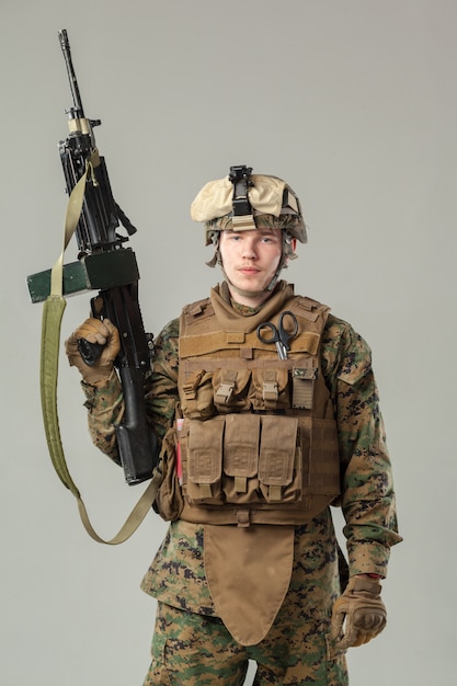 Soldier in camouflage holding rifle