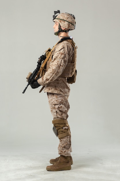 Soldier in camouflage holding rifle