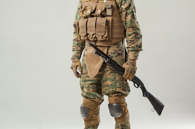 Soldier in camouflage holding rifle