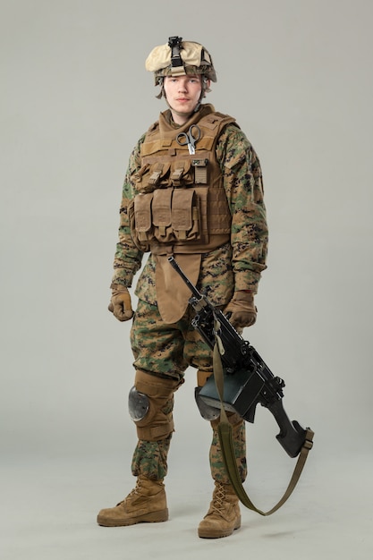 Soldier in camouflage holding rifle