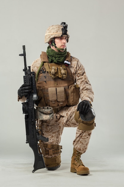 Soldier in camouflage holding rifle