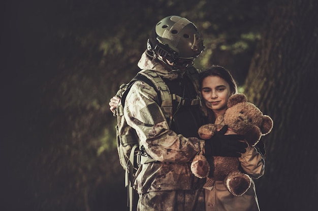 Photo soldier in camouflage return from mission and meeting his daughter