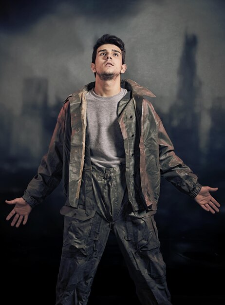 Soldier in chemical protection armor with ruins in background Final of war