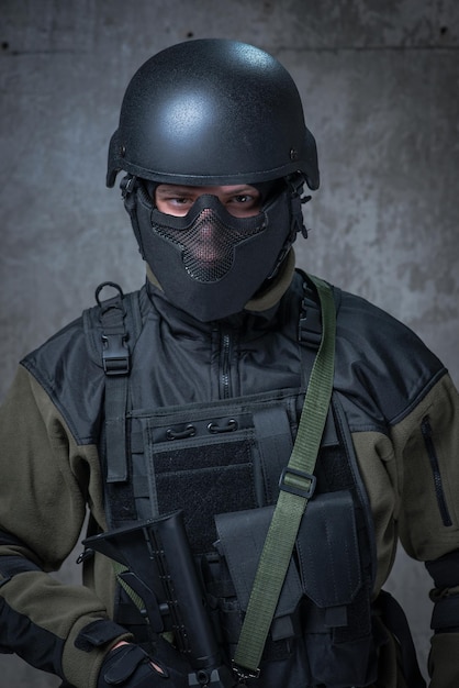 Soldier in helmet with automatic rifle in hands