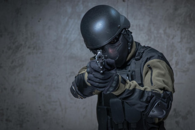 Soldier in helmet with big gun in hands