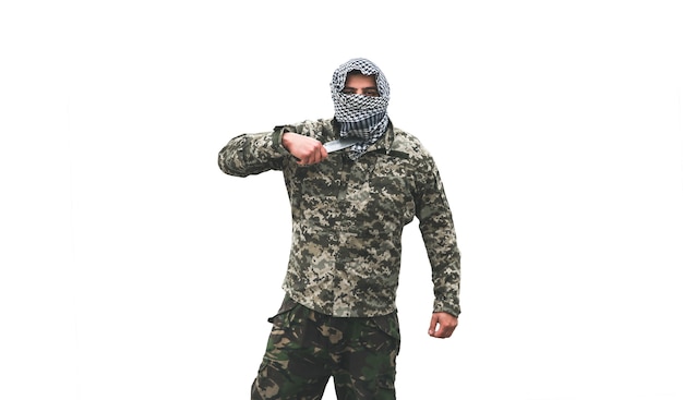 Soldier is standing in the camouflage uniform isolated on white background. Checkered keffiyeh shemagh bandana. Man with knife.