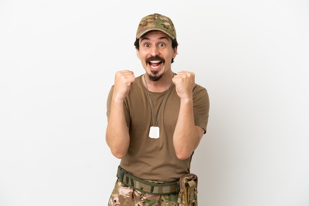 Soldier man isolated on white background celebrating a victory in winner position