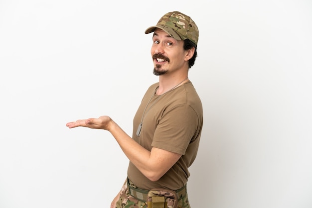 Soldier man isolated on white background presenting an idea while looking smiling towards