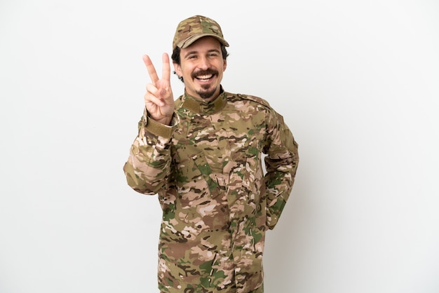 Soldier man isolated on white background smiling and showing victory sign