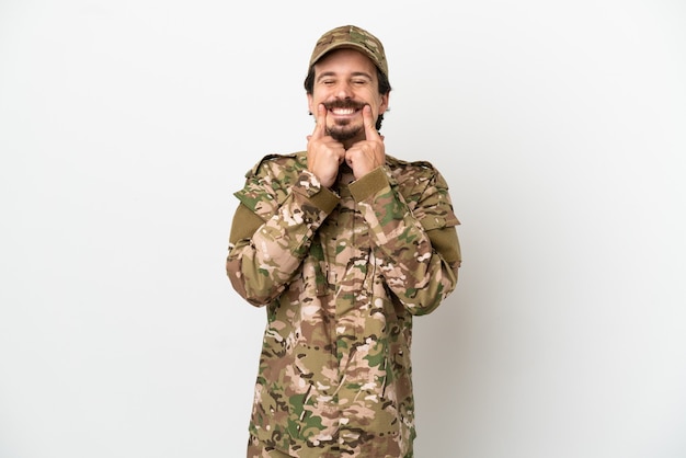 Soldier man isolated on white background smiling with a happy and pleasant expression