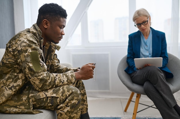 Soldier and psychotherapist in the office. consultation, support and therapy session in office. ptsd treatment