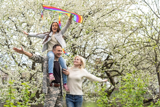 Soldier reunited with his family in park.