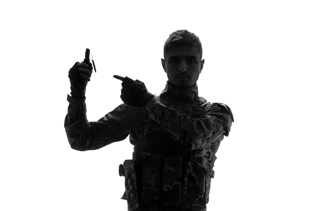 Soldier silhouette army tough handsome serious strong soldier in uniform pointing at grenade