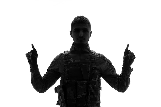 Soldier silhouette serious handsome strong tough army soldier in uniform holding hands up