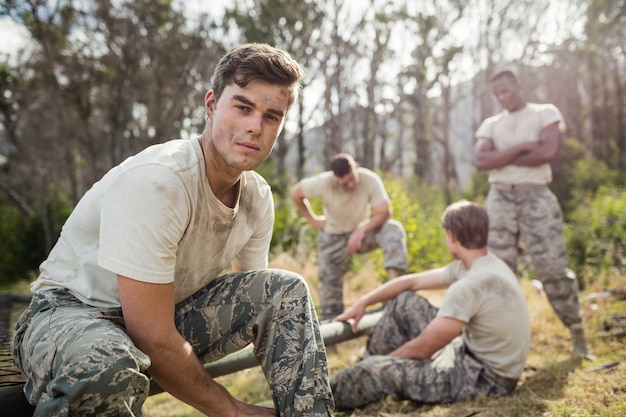 Soldier tying his shoe laces in boot camp