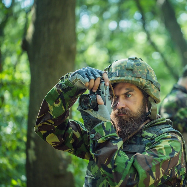 Soldier with camera in forest